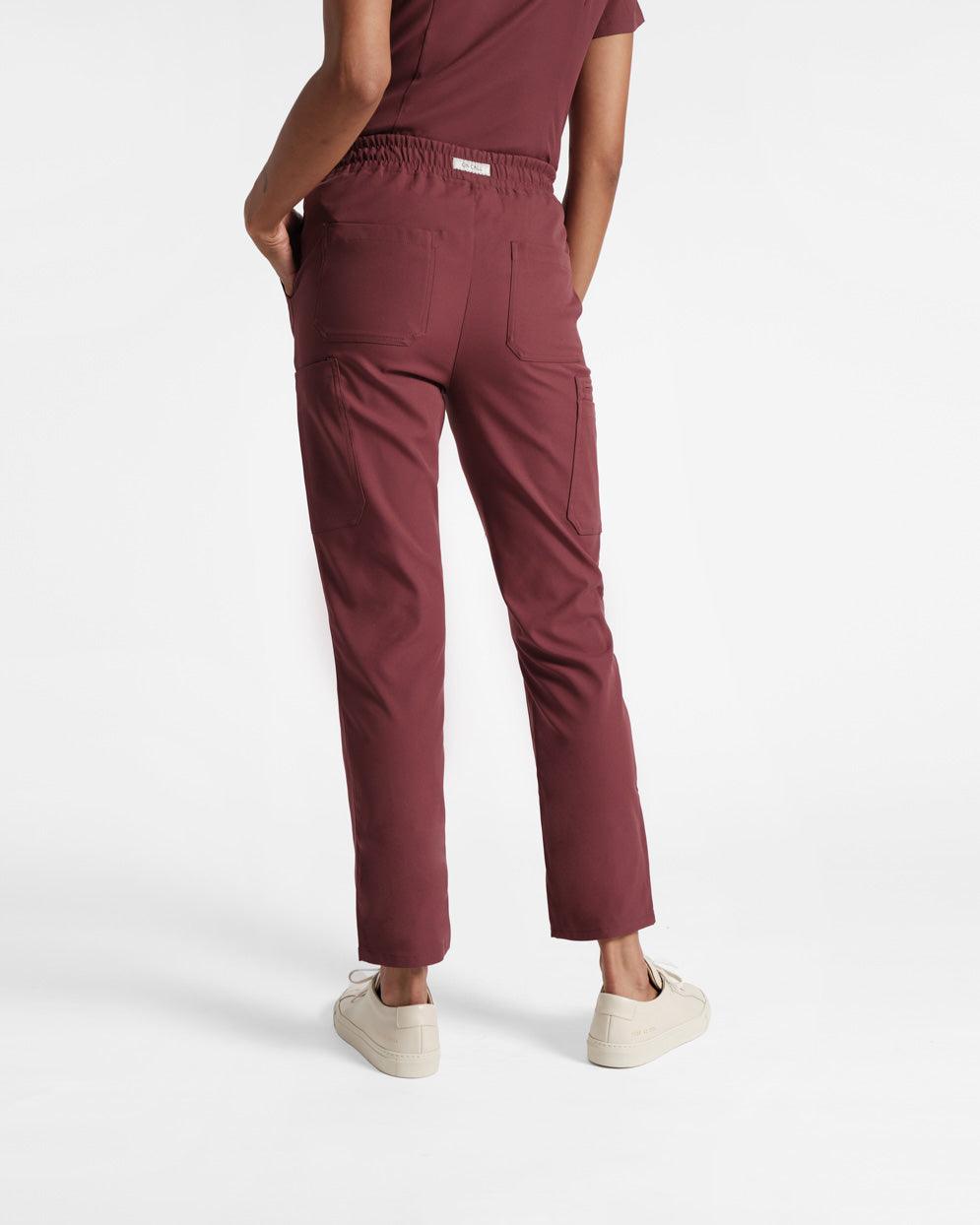 Back side view of woman in deep red cargo scrub pants with two back pockets.