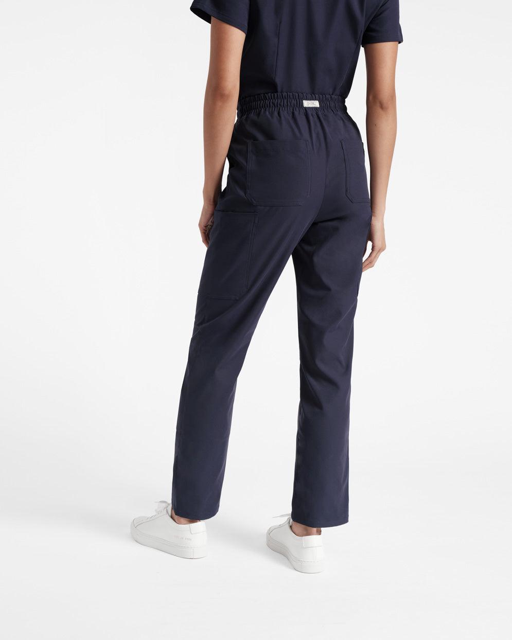 Back side view of woman in navy cargo scrub pants with two back pockets.