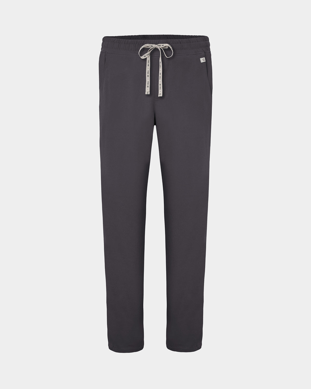 Dark grey straight leg scrub pants with a white logo drawstring and a small white logo on the left hip, shown against a light gray background.