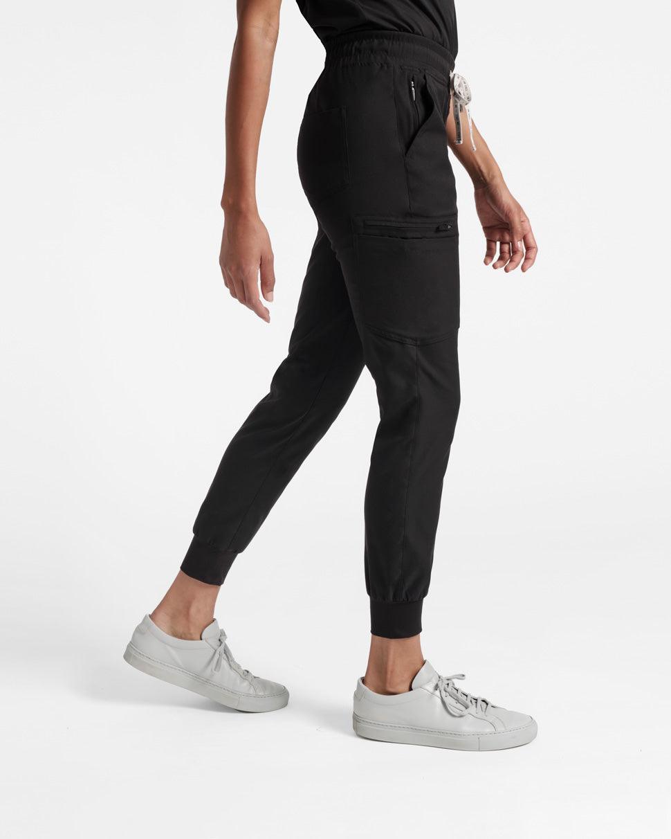 Side view of black cargo jogger scrub pants with elasticated cuffs.