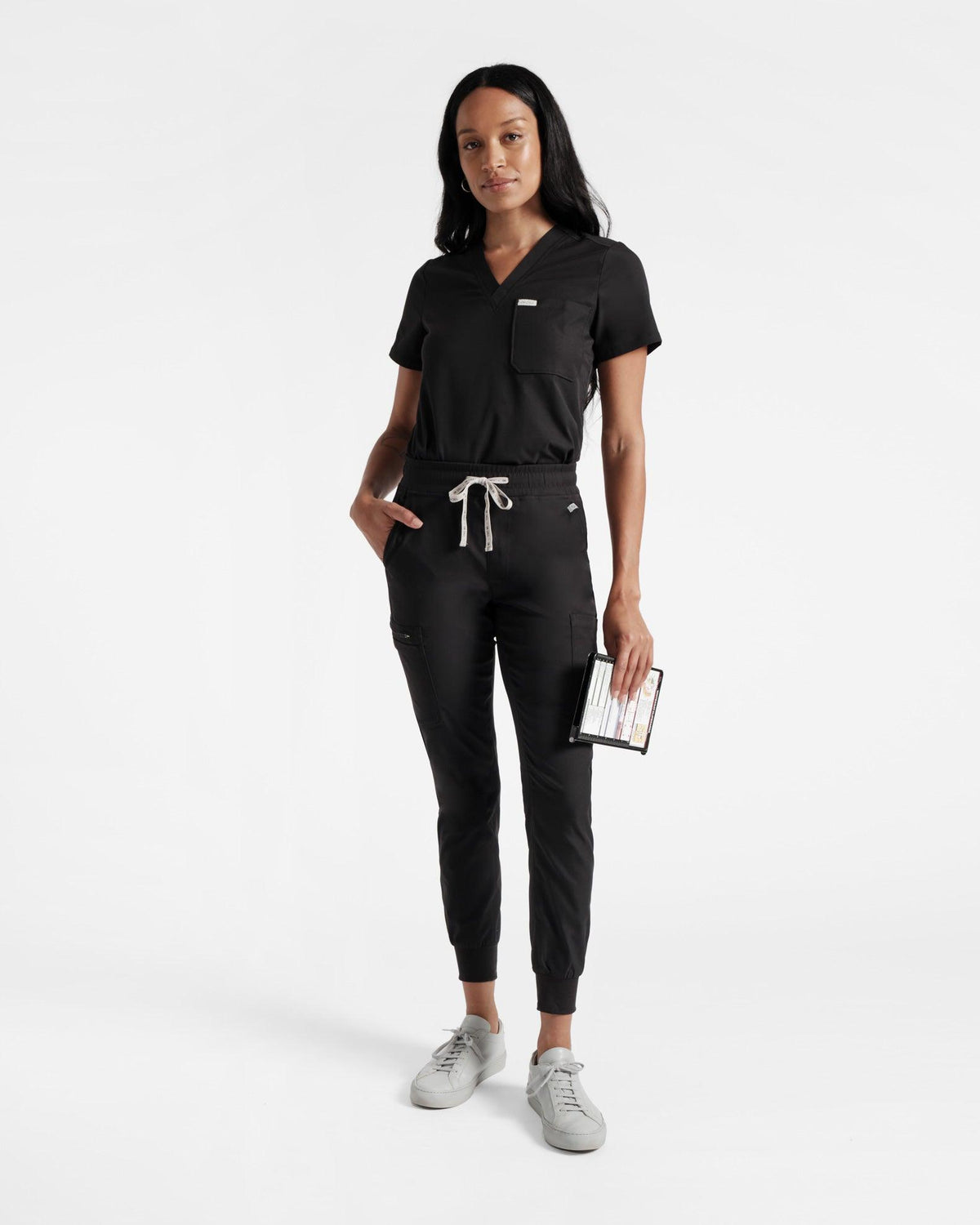 Model in black cargo jogger scrub pants with a matching top.