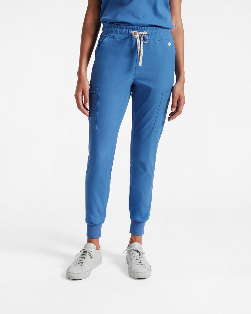 Model from the waist down in bright blue jogger cargo scrub pants with soft ribbed ankle cuffs.