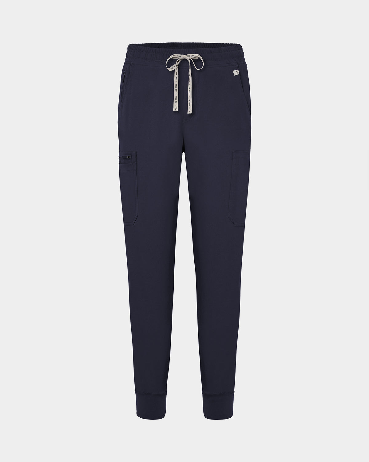Navy jogger-style scrub pants with a white drawstring, cargo pockets, and a small white logo on the upper right hip, shown against a light gray background.