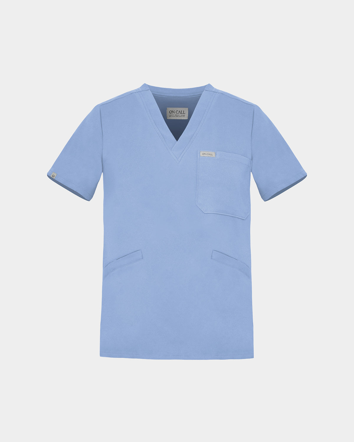 A light blue scrub top with a V-neck, short sleeves, a chest pocket, and two lower front pockets, shown on a light gray background.