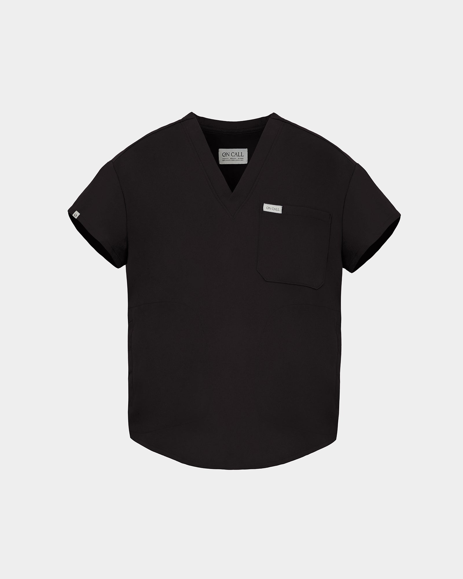 A black short-sleeve V-neck scrub top with a chest pocket and a small white brand tag, displayed on a light gray background.