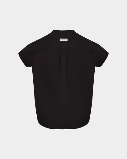 A black short-sleeve scrub shirt shown from the back, featuring a subtle center back pleat and a small white rectangular brand label at the collar, set against a light gray background.