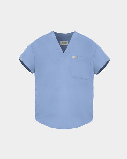 A light blue scrub top with short sleeves, a V-neckline, and a chest pocket, shown against a light gray background.