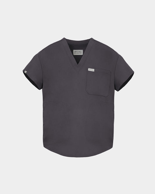 A dark gray V-neck scrub top with short sleeves, a chest pocket, and a small white brand tag on the left chest, displayed against a light gray background.