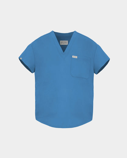 A bright blue V-neck scrub top with short sleeves, a chest pocket, and a small white brand tag, shown on a light gray background.