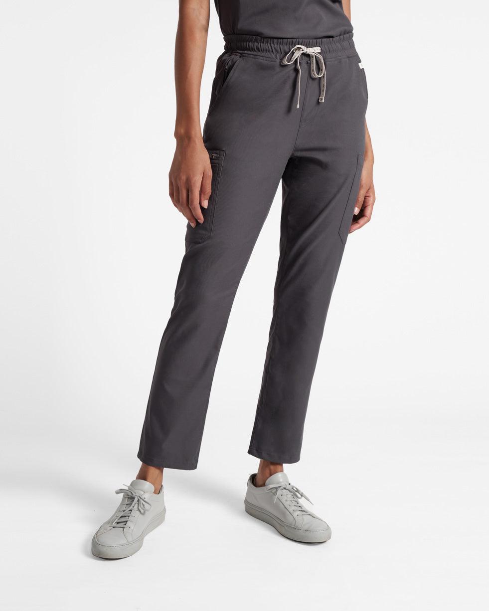 Waist down view of woman in dark grey cargo straight leg scrub pants. 