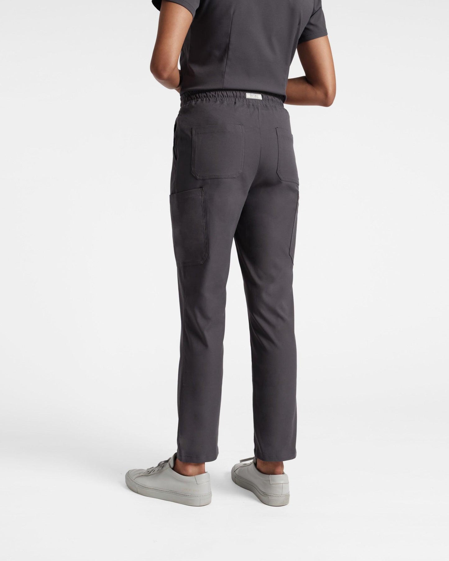 Back side view of women's cargo scrub pant in dark grey's