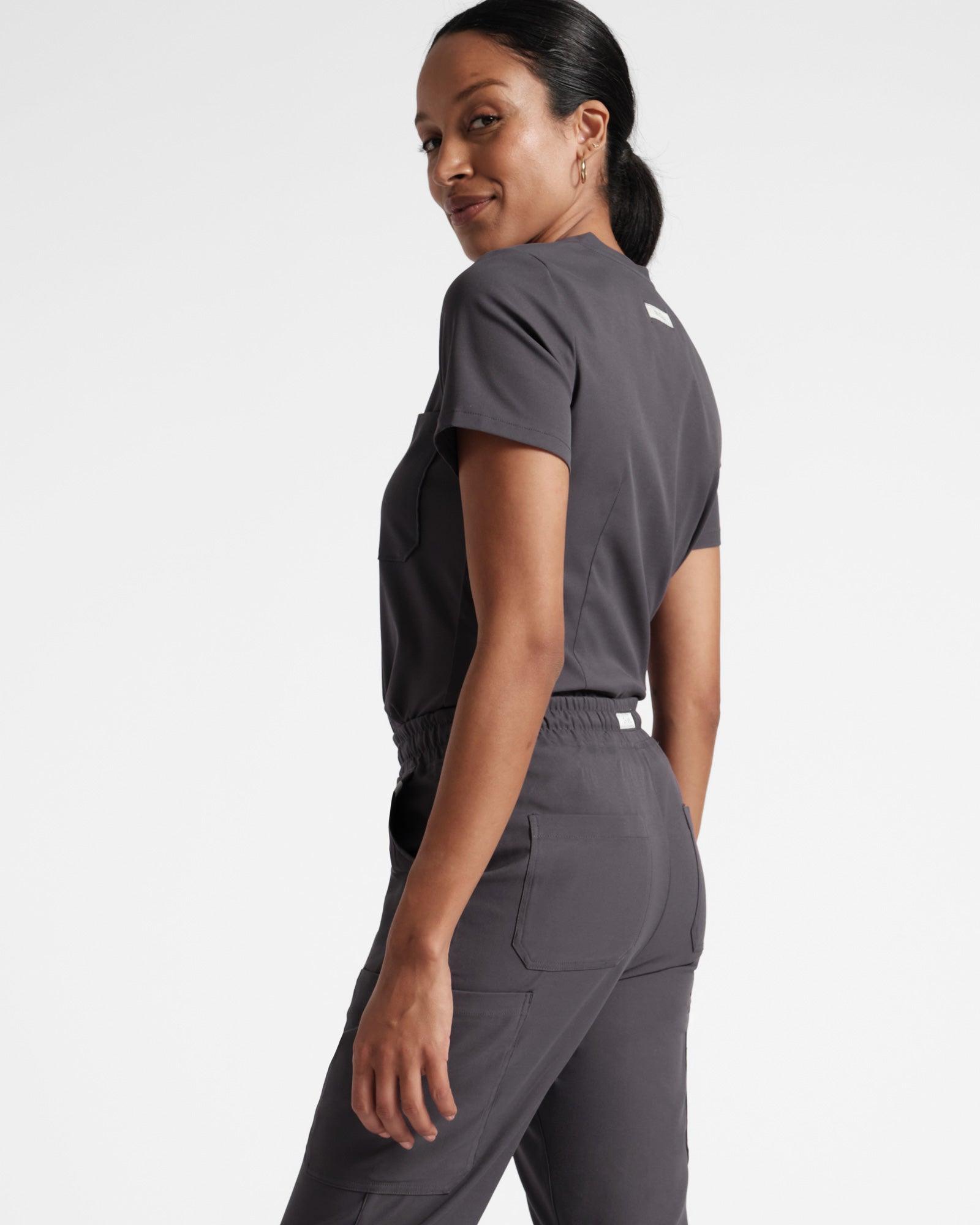 Back angled view of women's cargo scrub pant in dark grey's