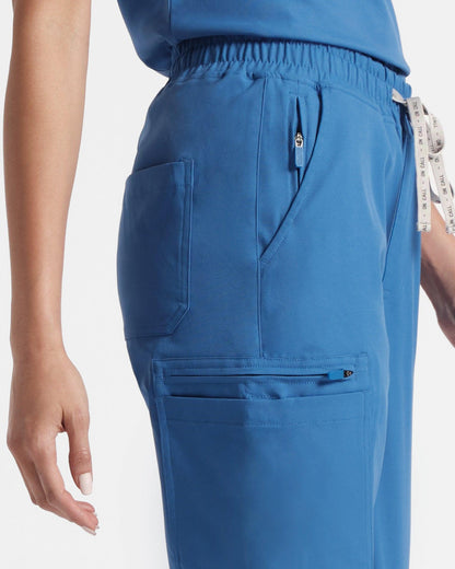 Close up of side pockets on women's cargo scrub pant in venous blue