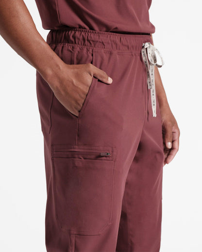 Close up side view of men's cargo scrub pant in heme red