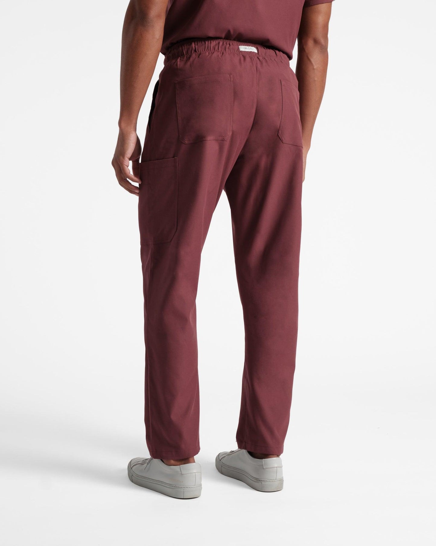 Back side view of men's carge scrub pant in heme red