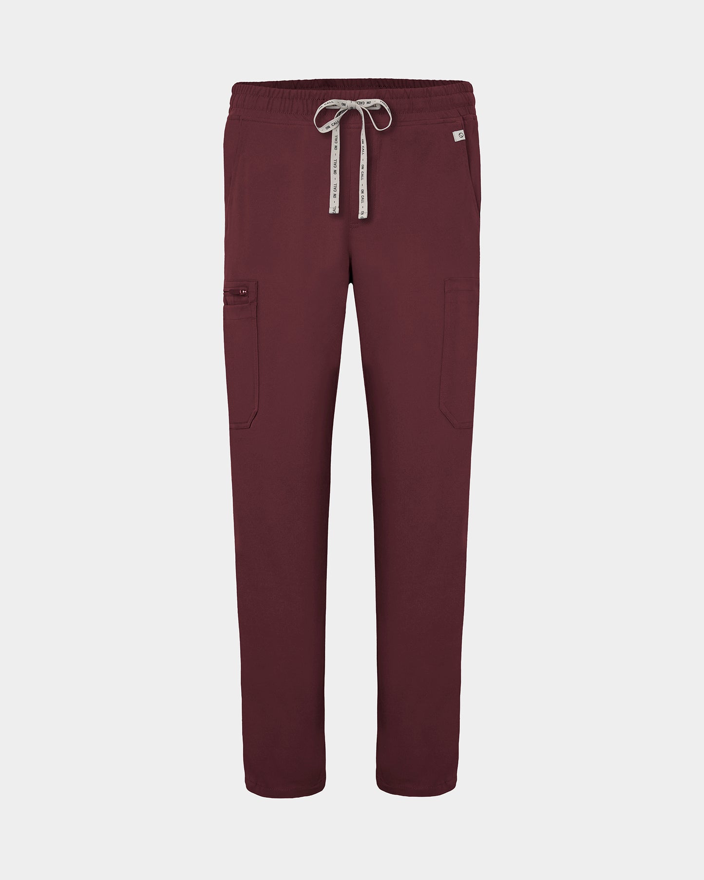 Heme red scrub pants with cargo pockets, a logo drawstring tie, set against a solid light grey background.
