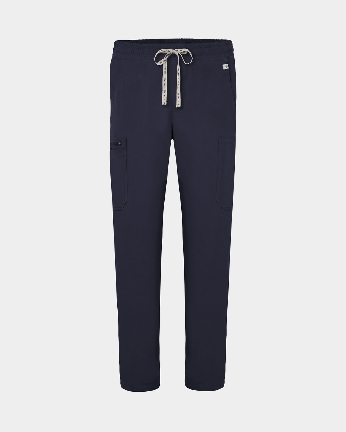 Navy scrub pants with cargo pockets, a logo drawstring tie, set against a solid light grey background.