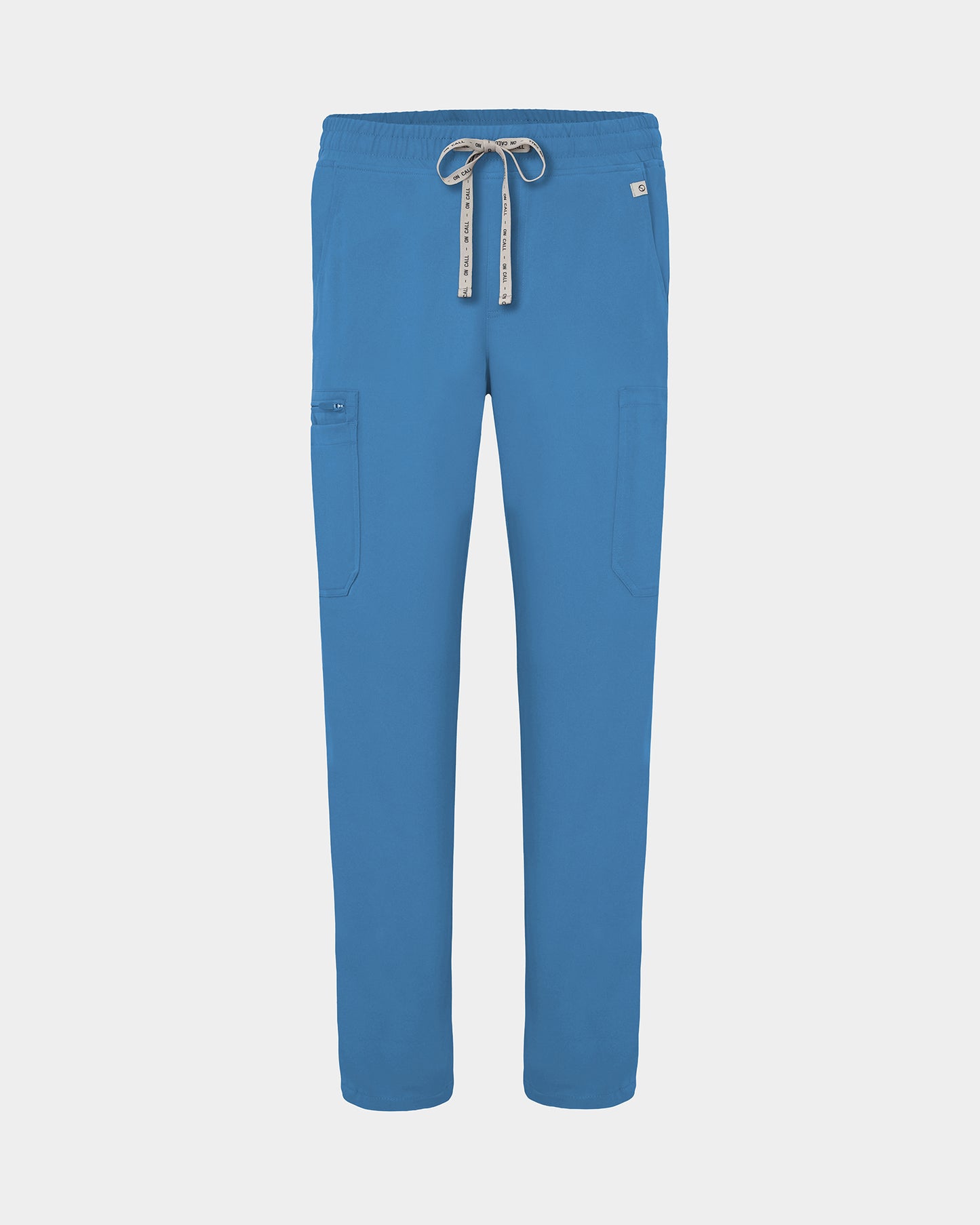 Bright blue scrub pants with cargo pockets, a logo drawstring tie, set against a solid light grey background.