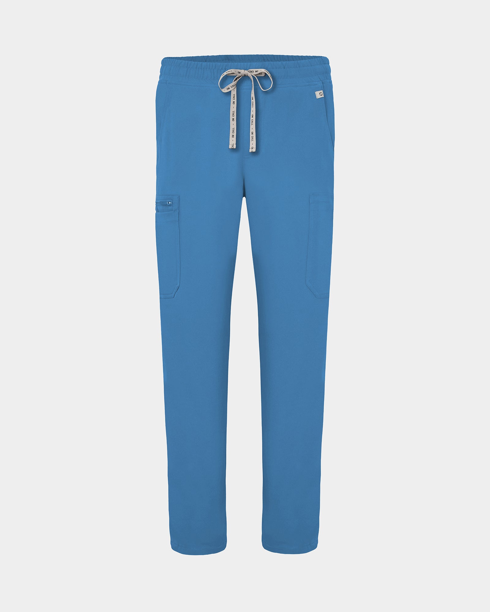 Bright blue scrub pants with cargo pockets, a logo drawstring tie, set against a solid light grey background.