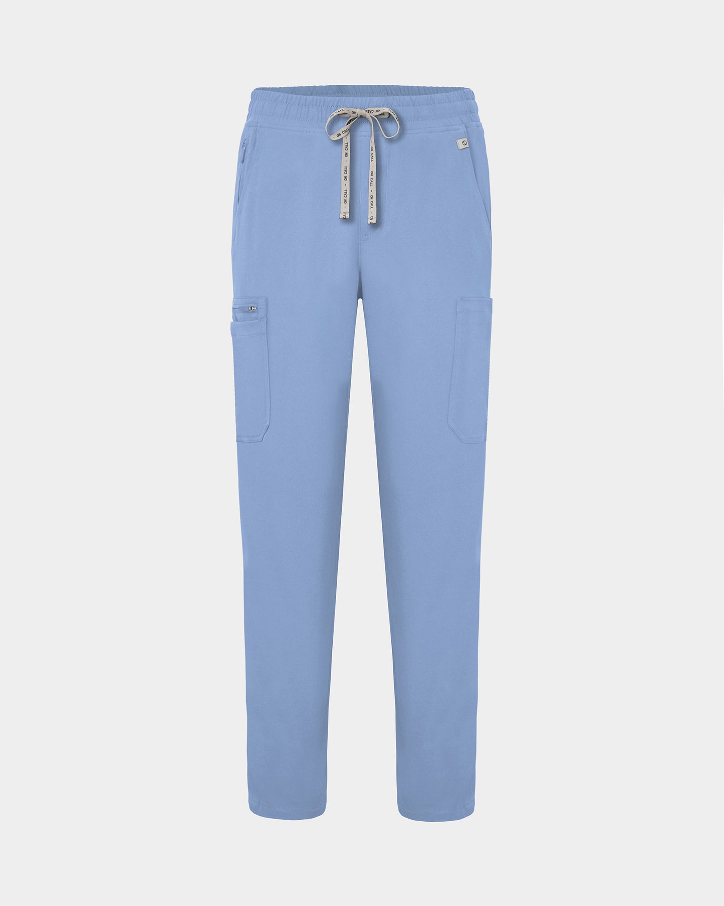 Light blue scrub pants with a drawstring waist, side cargo pockets, and a small logo on the upper right hip, shown against a light gray background.