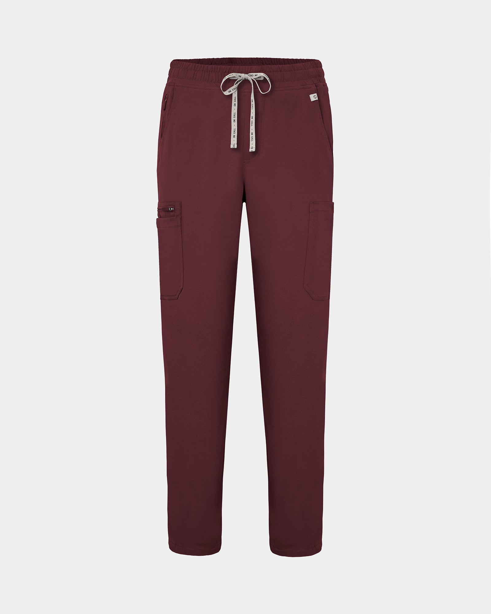 Heme red colored scrub pants with straight legs, cargo pockets, and a logo drawstring.