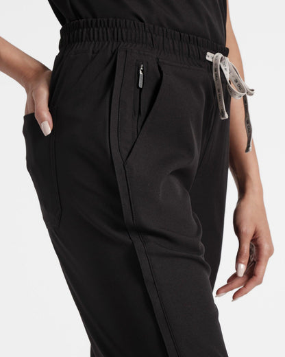 Close up of side of women's black straight leg scrub pant