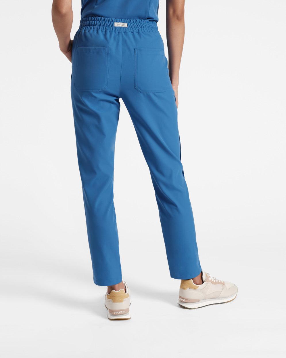 Back side view of woman wearing bright blue straight leg scrubs with two back pockets.