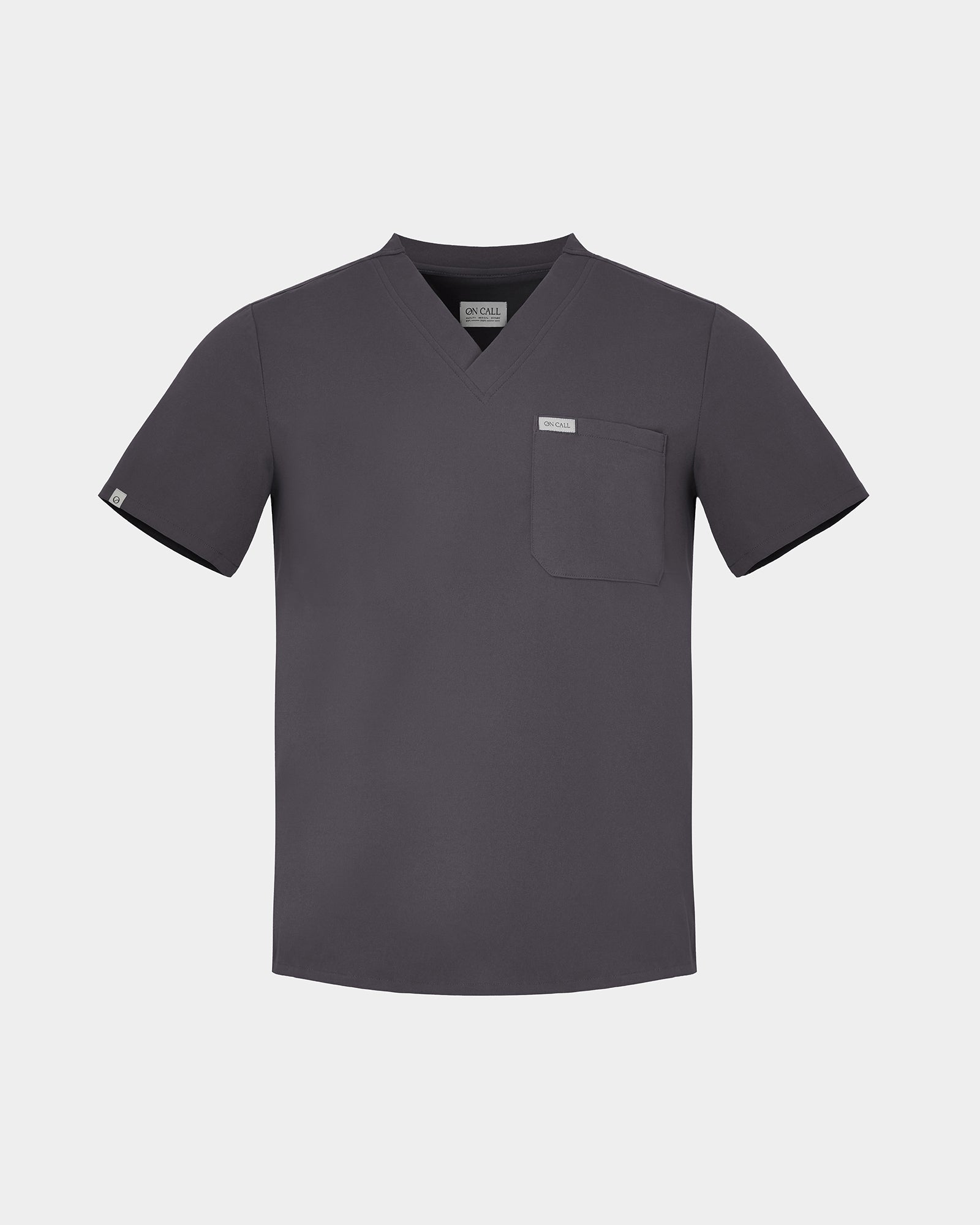 Dark grey short-sleeve men's scrub shirt on a grey background