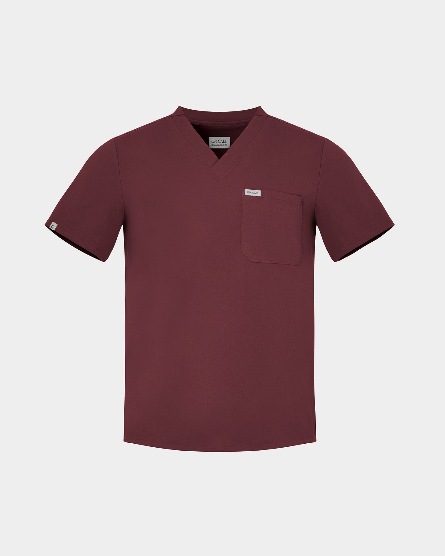 Heme Red v-neck scrub top with a chest pocket and a white logo label.