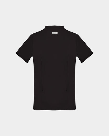 A back side view of a black short-sleeve scrub shirt with a logo label under the collar shown flat against a light gray background.
