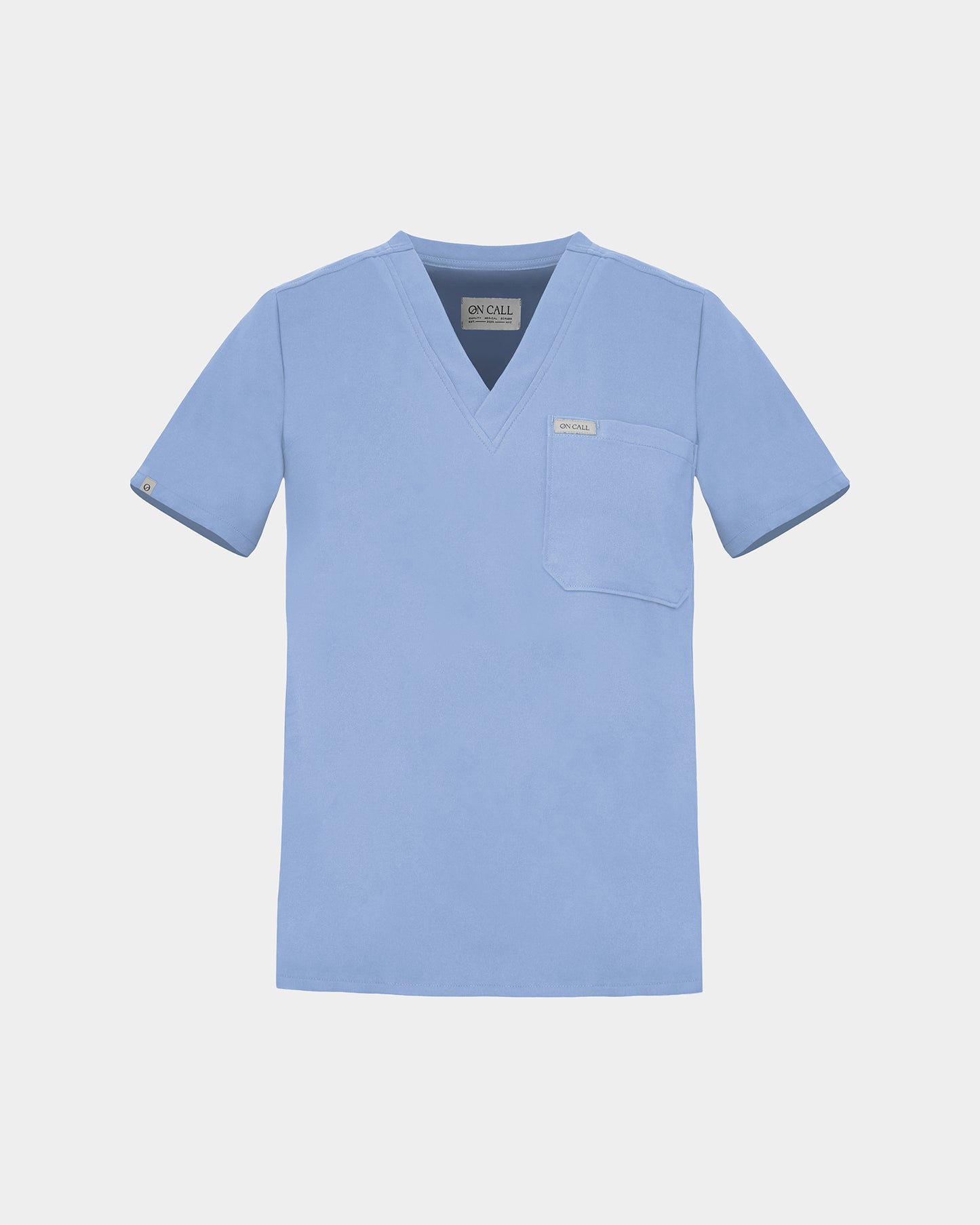 A light blue scrub top with a V-neck, short sleeves, and a chest pocket, displayed flat against a light gray background.