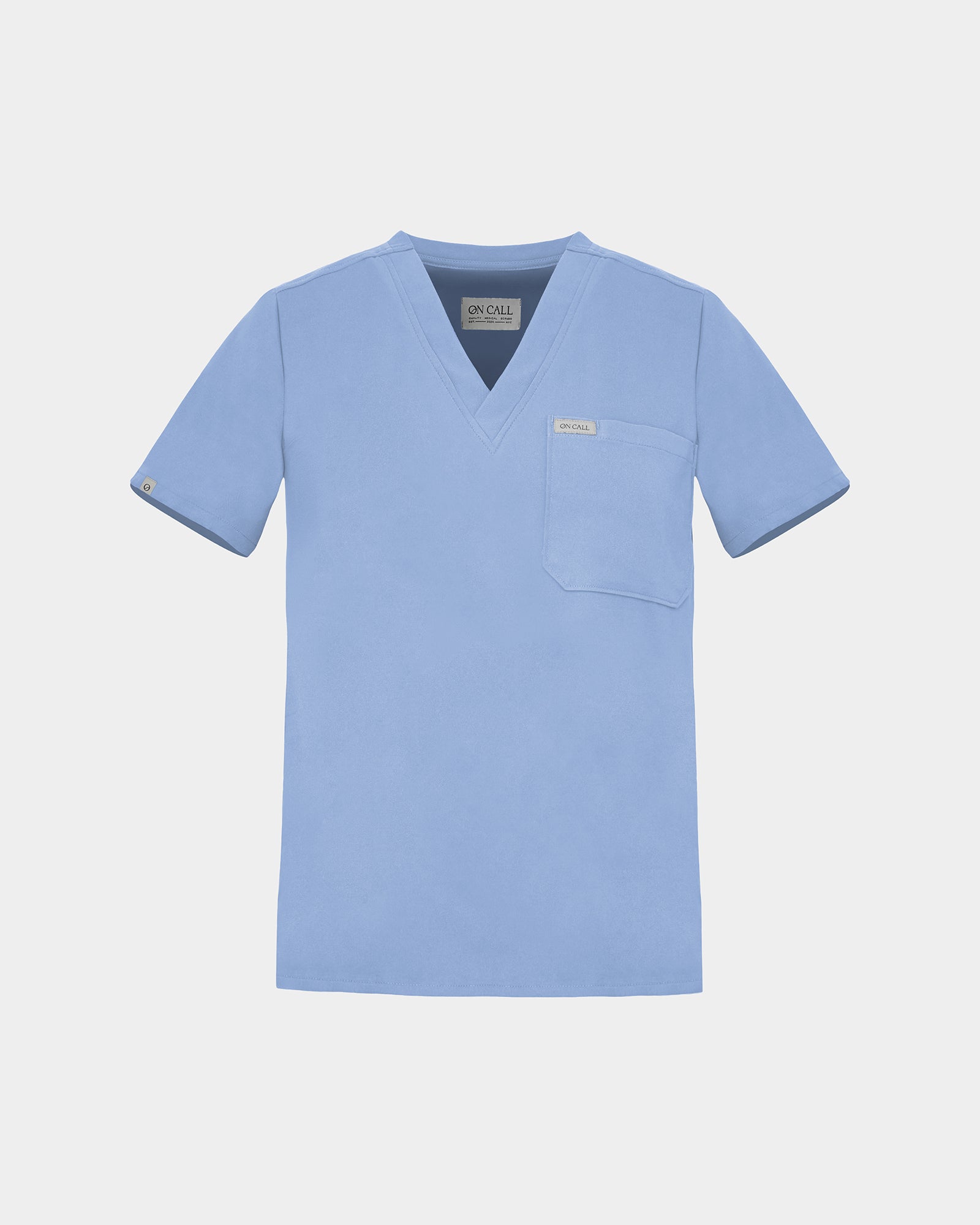 A light blue scrub top with a V-neck, short sleeves, and a chest pocket, displayed flat against a light gray background.