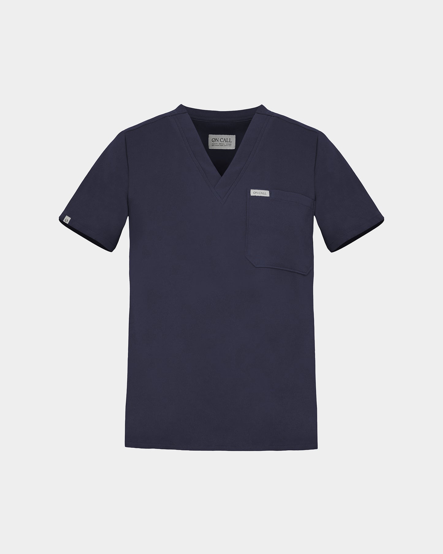 Navy v-neck scrub shirt with a chest pocket featuring a logo label on the pocket and on the sleeve.