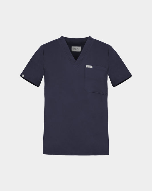 Navy v-neck scrub shirt with a chest pocket featuring a logo label on the pocket and on the sleeve.