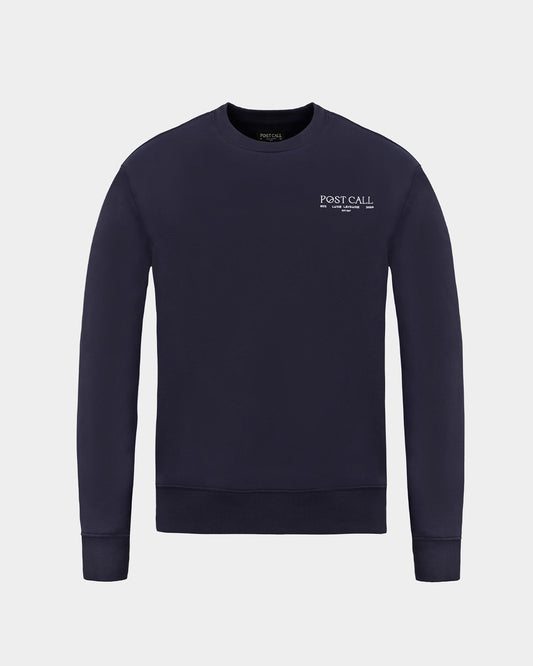 A dark navy blue crewneck sweatshirt with 'POST CALL' embroidered in white on the left chest, displayed on a clean light gray background.