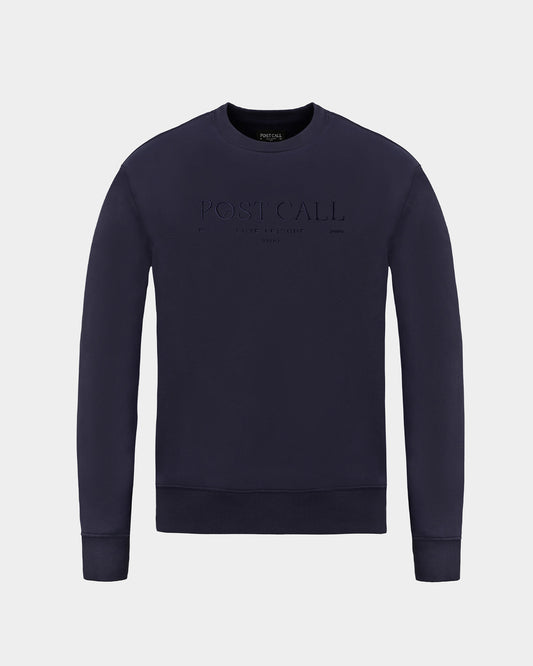 A dark navy blue crewneck sweatshirt with 'POST CALL' embroidered in tonal thread across the chest, displayed on a light gray background.