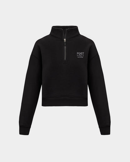 A black half-zip sweatshirt with a small white 'POST CALL' logo on the left chest, displayed on a clean light gray background.