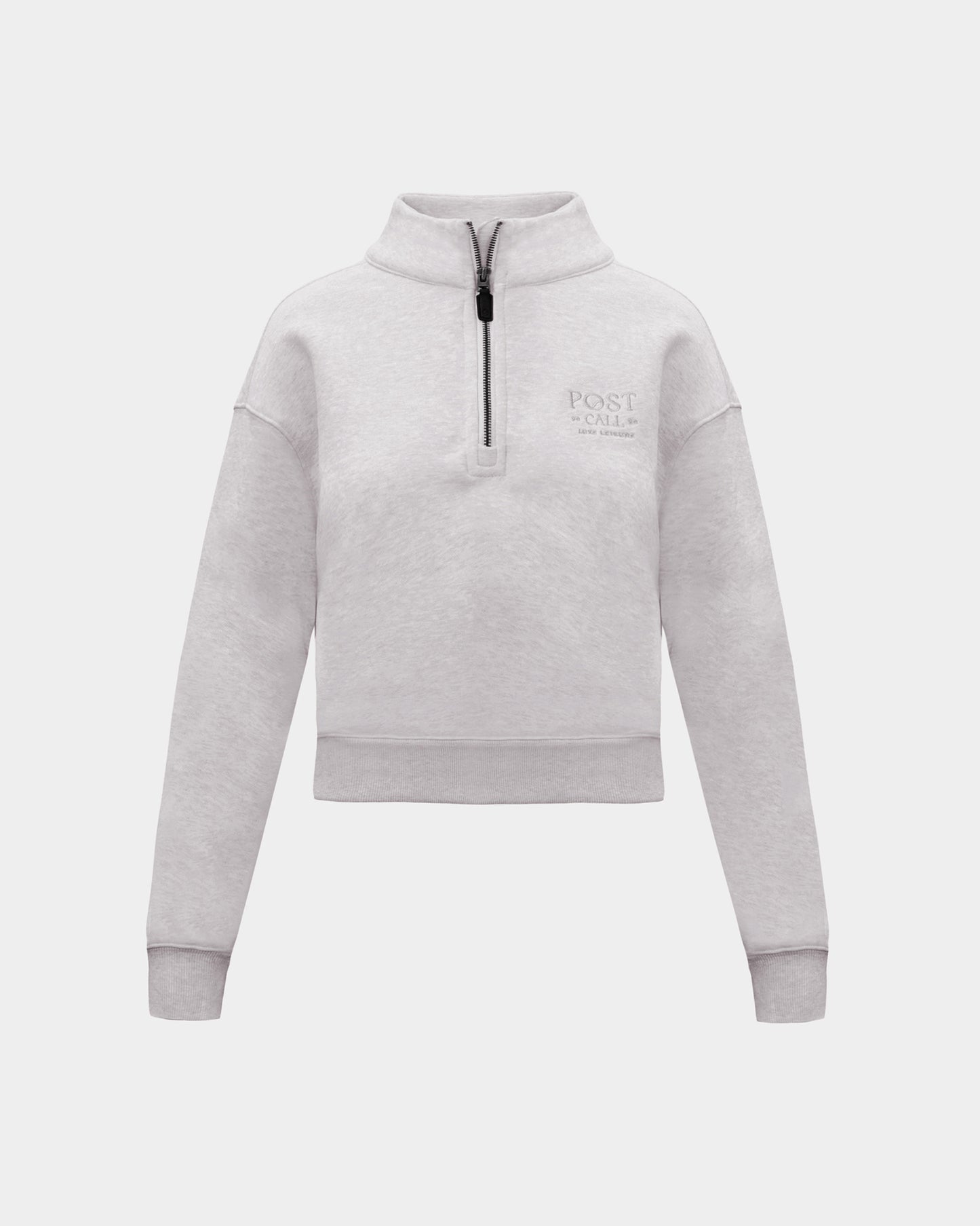 A heather grey long-sleeve quarter-zip pullover sweatshirt with a small tonal 'POST CALL' logo on the left chest,  displayed on a clean light gray background.