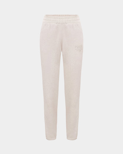 Heather beige lounge pants with a thick elasticated waistband, hidden drawstring, elasticated ankle cuffs, and tonal logo embroidery on the left thigh.