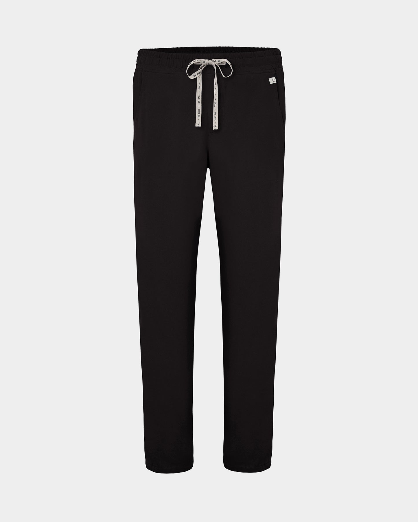 Black straight leg scrub pants with a white logo drawstring and a small white logo on the left hip, shown against a light gray background.