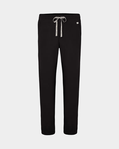 Black straight leg scrub pants with a white logo drawstring and a small white logo on the left hip, shown against a light gray background.
