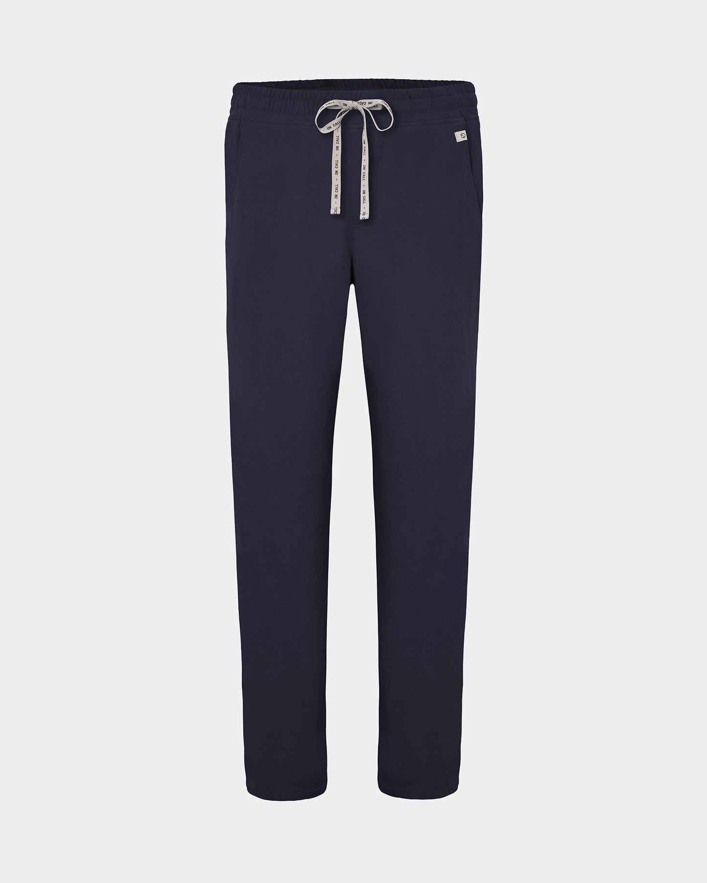 Navy straight leg scrub pants with a white logo drawstring and a small white logo on the left hip, shown against a light gray background.