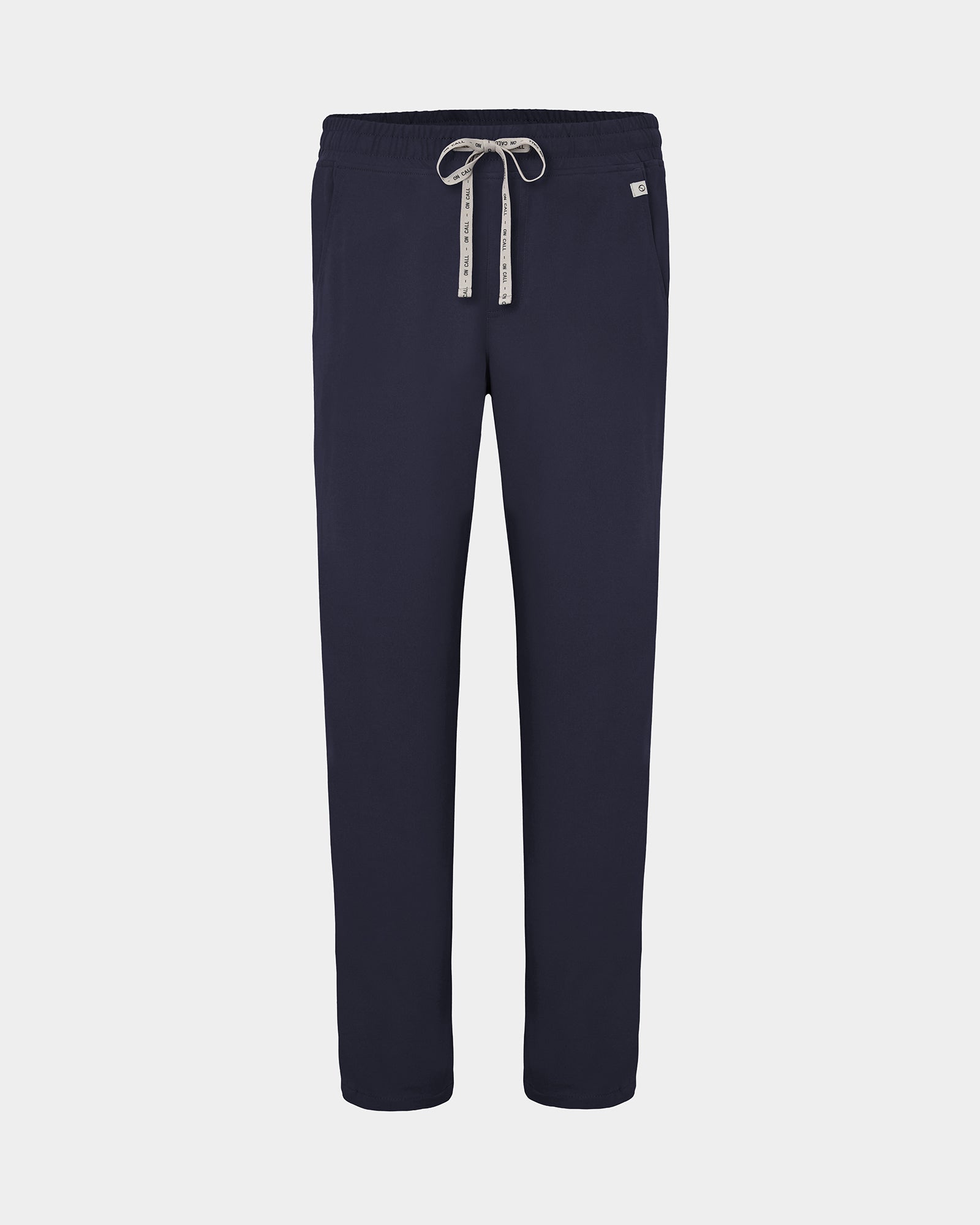 Navy straight leg scrub pants with a white logo drawstring and a small white logo on the left hip, shown against a light gray background.