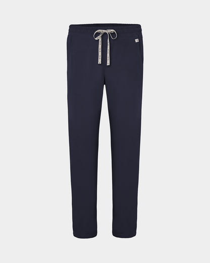 Navy straight leg scrub pants with a white logo drawstring and a small white logo on the left hip, shown against a light gray background.