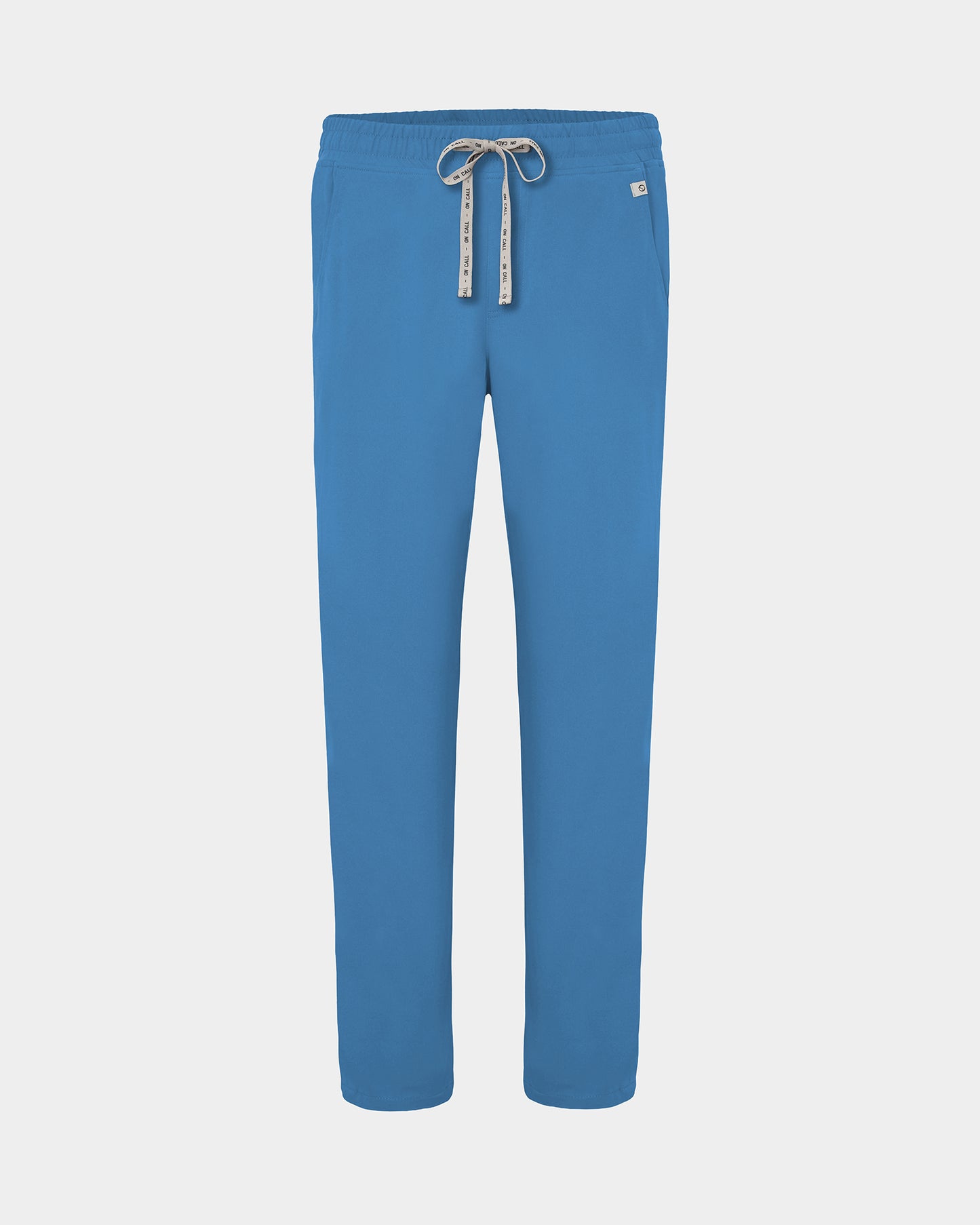 A pair of bright blue scrub pants with a white drawstring featuring black lettering, shown against a light gray background.