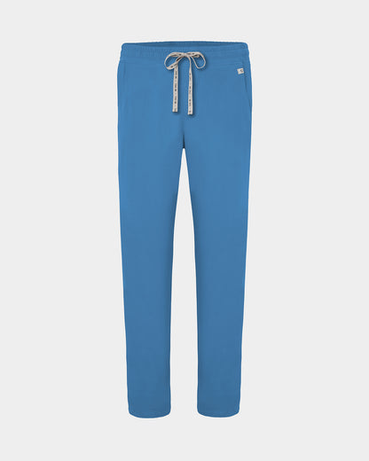 A pair of bright blue scrub pants with a white drawstring featuring black lettering, shown against a light gray background.