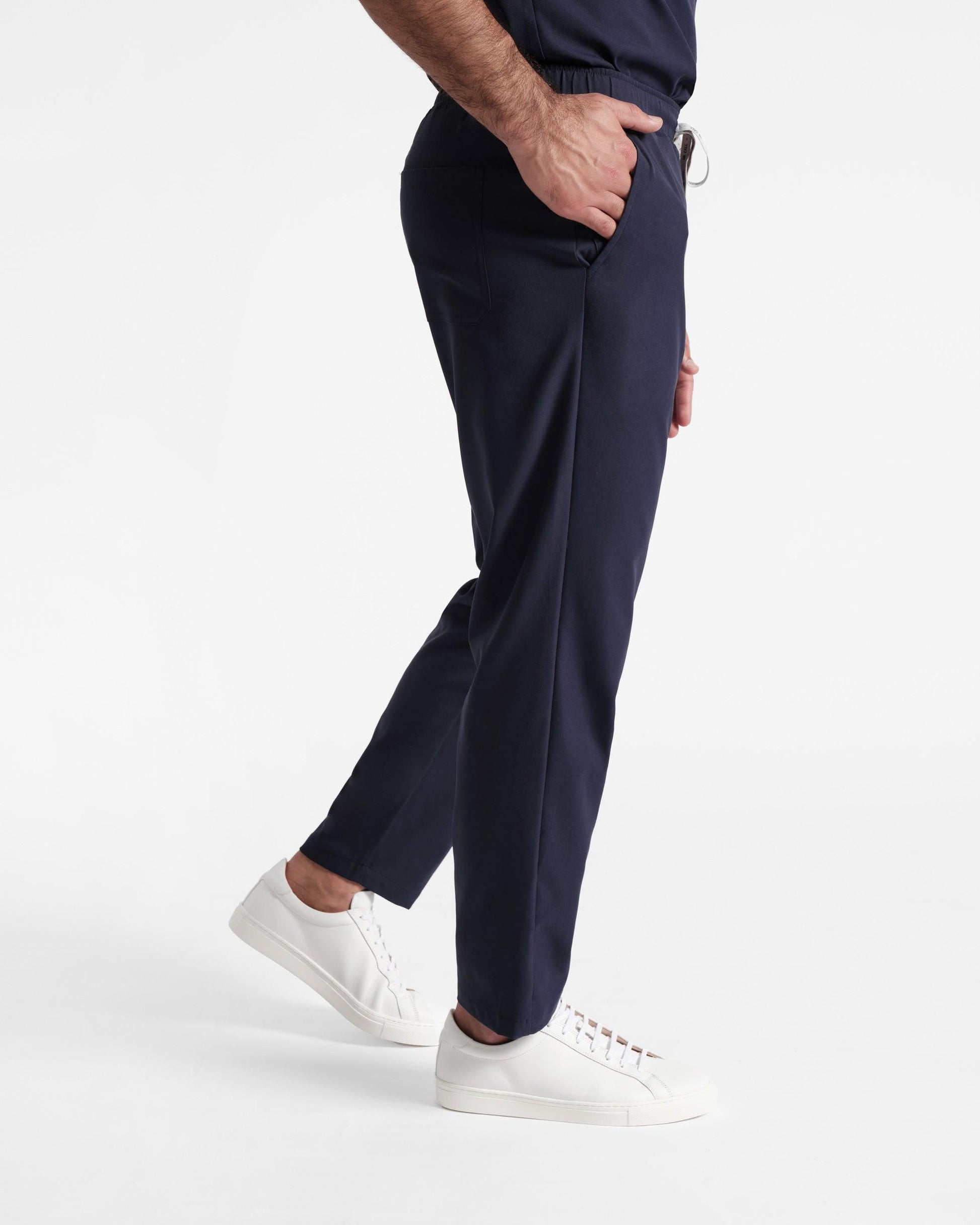 Side view of navy men's straight leg scrub pant with pockets