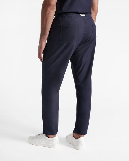 Back side shot of navy straight leg men's scrub pant with pockets