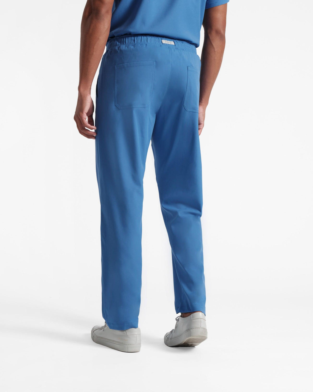 Back side view of man in bright blue scrub pants with two back pockets. 