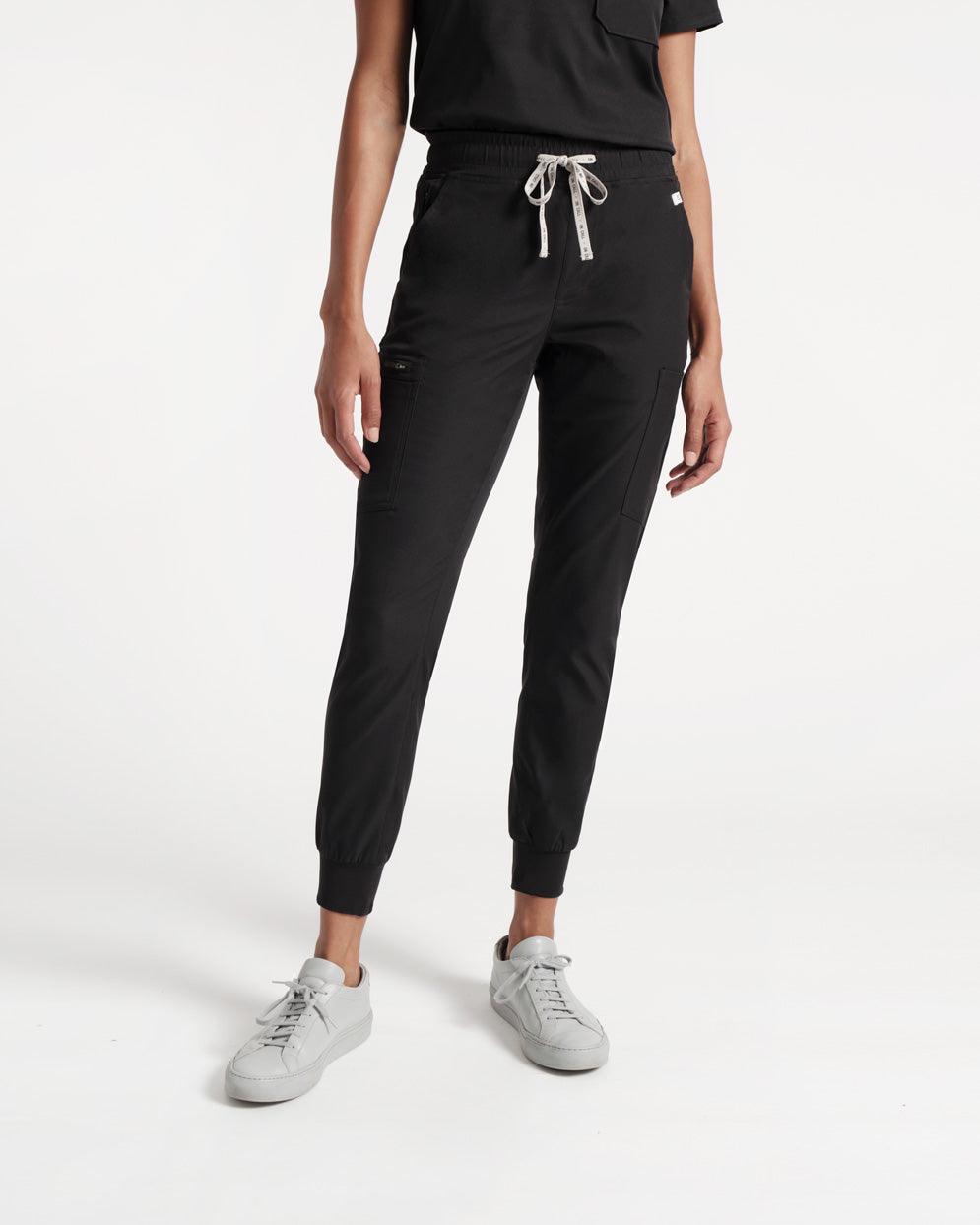 Front side view of black cargo jogger scrub pants with branded waistband tie.